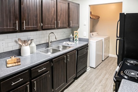 Kitchen with in unit laundry located at Addison on Cobblestone located in Fayetteville, GA 30215